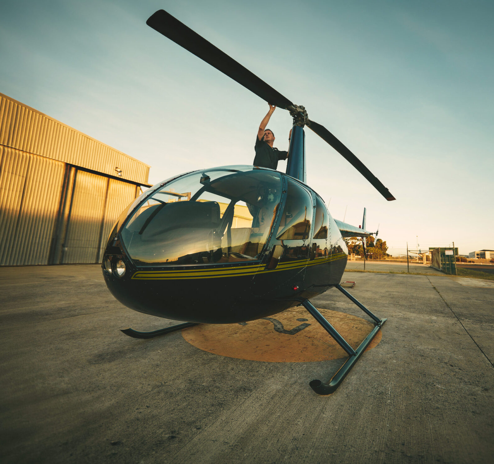 Pilot inspecting helicopter